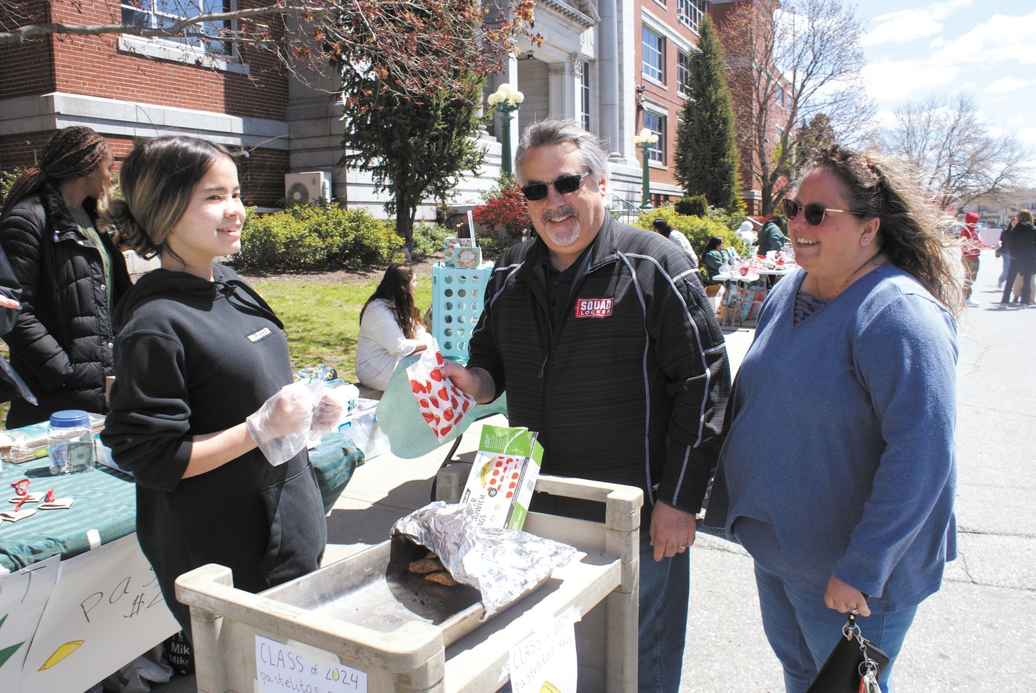 LUNCHTIME: Jess Tran, a student at Cranston High School East sold snacks to Domenic and Shelly.